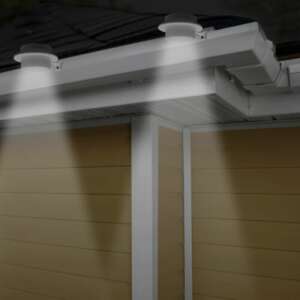 Solar gutter light illuminating a fence - Garden