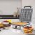 Cecotec Fun Gofrestone waffle maker in kitchen setting with waffles and fruit