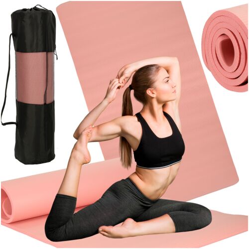 Woman using pink yoga mat with carrying bag and rolled mat