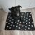 Happy dog sitting on Purlov XXL black paw print dog bed