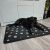Dog relaxing on Purlov XXL black paw print dog bed