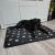 Dog relaxing on Purlov XXL black paw print dog bed