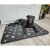 Dog relaxing on Purlov XXL black paw print dog bed