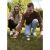Two people playing Kruzzel bocce ball set on grass