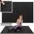 Woman exercising on Springos black puzzle exercise mat