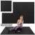 Woman exercising on Springos black puzzle exercise mat