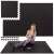 Woman exercising on Springos black puzzle exercise mat