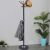 Springos black standing coat rack with marble base in use.