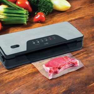 Home vacuum sealer in use with a vacuum sealed bag of meat - Home Vacuum Sealer