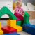 Toddler playing with IGLU Soft Play colorful foam blocks