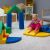 Toddler playing on IGLU Soft Play colorful foam blocks, climbing and sliding