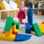 Girl playing with IGLU SOFT PLAY colorful foam blocks in playroom