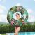 Teenage girl holding Bestway Floral Fantasy swim ring outdoors, smiling