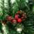 Close-up of Ruhhy Christmas garland with pine cones and red berries