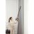 Woman using Dreame T30 cordless vacuum cleaner to clean curtains