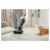Woman using Sencor SVC 0618TI handheld vacuum on sofa