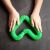 Child playing with green Kruzzel pop tube sensory toy
