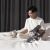Man using Dreame V11 handheld vacuum on bed with cat