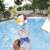 Dzieci bawią się Bestway 61cm dmuchana piłką plażową w basenie