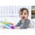 Happy baby playing with Baby Einstein Glow & Discover Light Bar on tummy