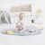 Baby sitting on Skip Hop Silver Lining Cloud play mat with cloud toy