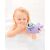 Child holding Skip Hop Narwhal bath toy in bath