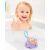 Child playing with Skip Hop Narwhal bath toy in tub