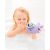 Child holding Skip Hop Narwhal bath toy in bath