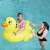 Child riding on Bestway Inflatable Duck Rider 135x91cm in a swimming pool