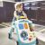 Baby using the Baby Einstein Musical Mix 'N Roll 4-in-1 Activity Walker as a walker