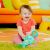 Baby playing with Bright Starts Tug Tunes Elephant Toy on playmat