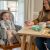 Baby eating in Ingenuity Proper Positioner high chair at table