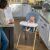 Baby eating snacks in Ingenuity high chair in kitchen
