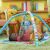 Baby reaching for elephant toy on Bright Starts Wild Wiggles Activity Gym