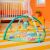 Bright Starts Wild Wiggles Activity Gym with hanging toys in a nursery setting