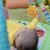 Baby reaching for sun toy on Bright Starts Wild Wiggles Activity Gym