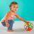 Baby playing with OBall Rollin Rainstick rattle