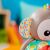 Close-up of the Bright Starts Grab & Giggle Monkey's ear, featuring a colorful geometric pattern