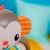 Close-up of the Bright Starts Grab & Giggle Monkey's ear, featuring a colorful striped pattern