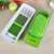 Nice Dicer Plus vegetable slicer, green and white, open, showing the different blades