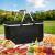 Termikus black foldable picnic basket in use with food and drinks