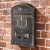STR 252261 bronze aluminum mailbox mounted on brick wall, outdoor postal box