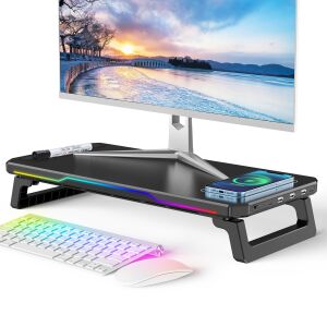 Monitorállvány USB hub-bal, vezeték nélküli töltéssel és RGB világítással, modern irodai környezetben. - Zadabso