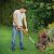 Man using Black & Decker ST182320-QW cordless grass trimmer to edge lawn