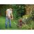 Man using Black & Decker ST182320-QW cordless grass trimmer to edge lawn