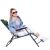 Springos green folding sun lounger, woman sitting