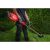 Person using Milwaukee M18 FUEL 2-in-1 cordless string trimmer and hedge trimmer