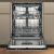Open Whirlpool WH6IC16B4M6T0 built-in dishwasher showing interior racks