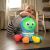 Happy baby playing with Baby Einstein Go Opus Go toy