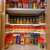 White spice rack organizer in a kitchen cabinet, before and after organization